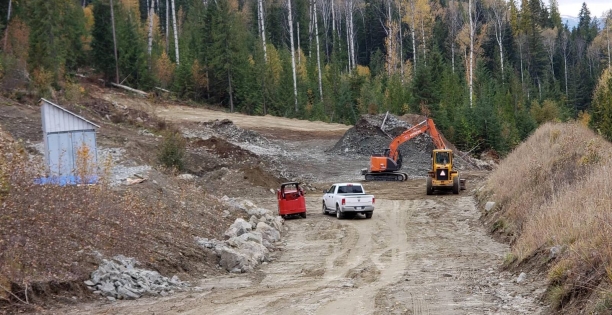 A truck and a tractor on a dirt road AI-generated content may be incorrect.